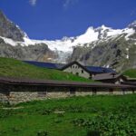 Il Rifugio Elena (2066 m), con l'aspro vallone di Pré de Bar sullo sfondo.